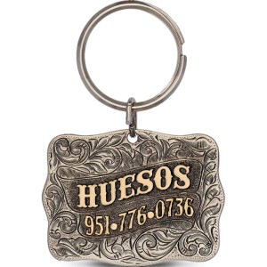 A custom dog tag with personalized engraved bronze lettering built on a silver base, western designed 