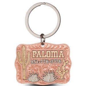 A custom dog tag with personalized engraved bronze lettering built on a copper base, featuring bronze cactus, western designed